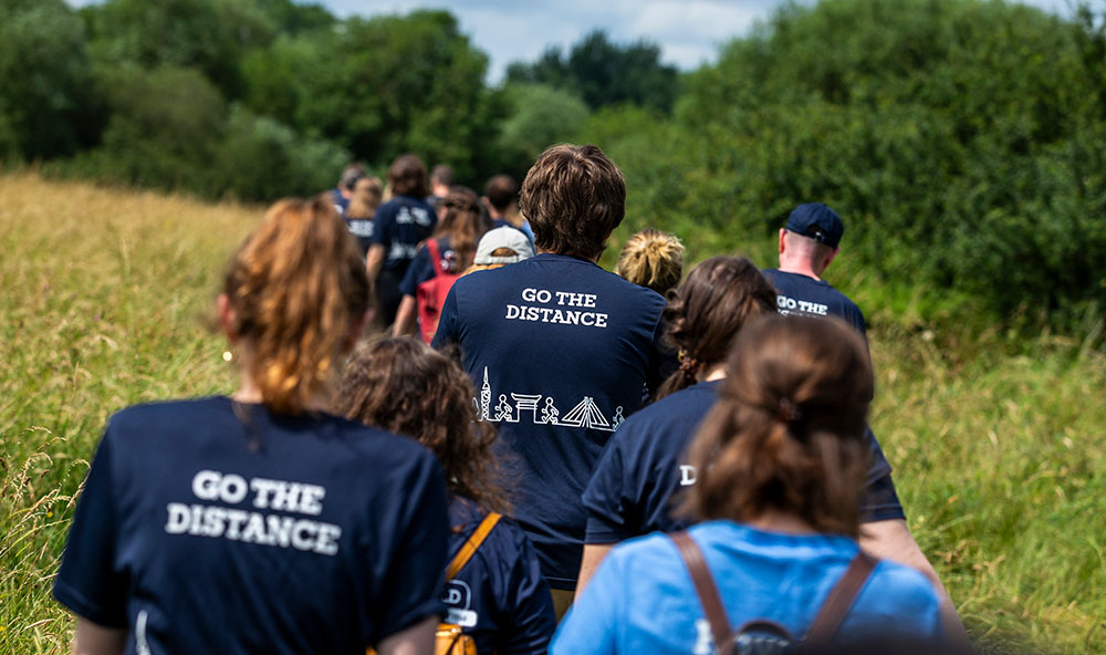 The back of a Taylor & Francis colleagues wearing a Walk the World t-shirts reading ‘Go the distance’.