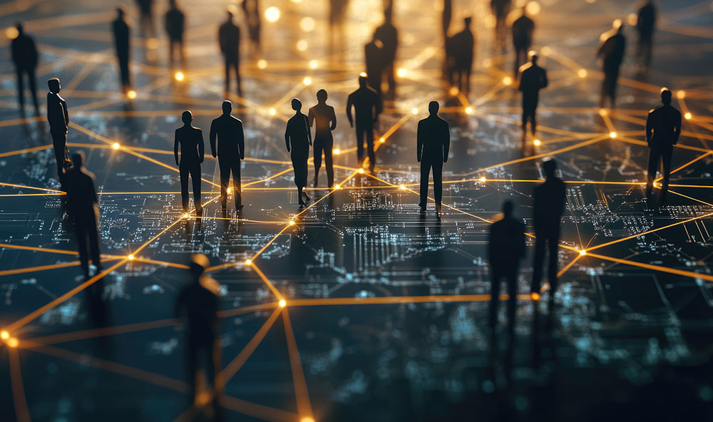 Silhouetted figures standing on a digital surface illuminated by glowing connection points and circuit-like pathways, symbolizing global connectivity and corporate network solutions.