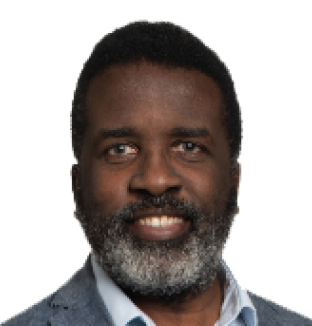 Headshot of Leon Heward-Mills, Managing Director Academic and Chief Content Officer at Taylor & Francis, wearing a light blue shirt with a grey blazer