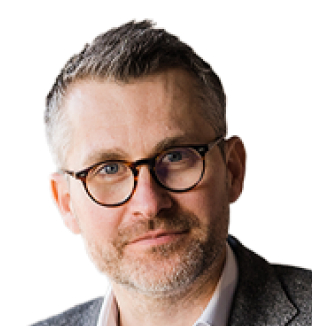 Headshot of Stuart Blackley, Executive Vice President of Operations at Taylor & Francis, wearing a white shirt and a grey blazer