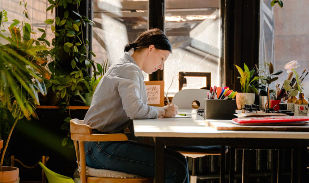 Editor sat at desk writing